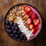 coconut berry smoothie bowl topped with granola and berries